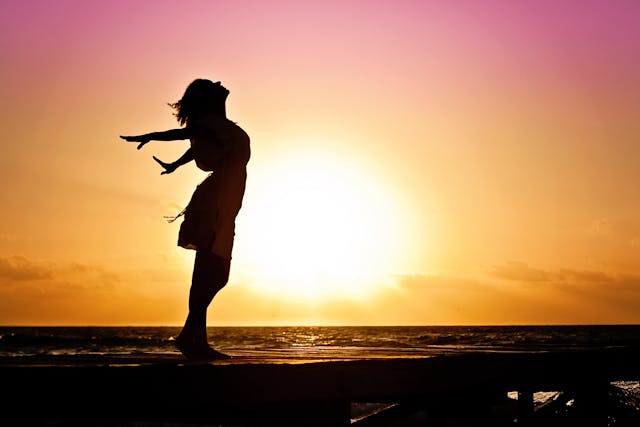 A woman stretching at dawn